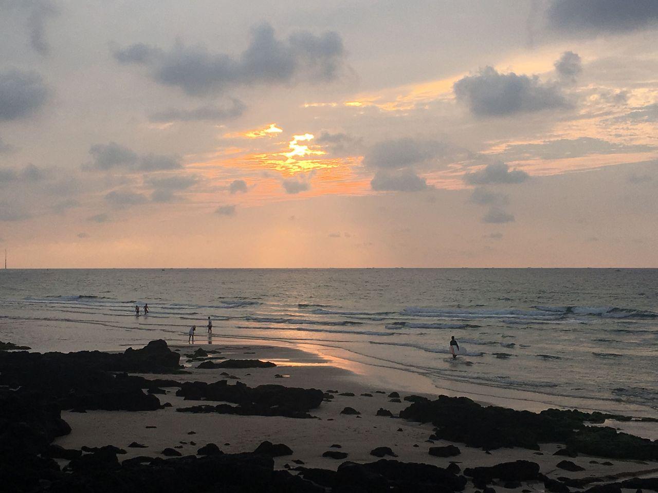 Aewol Handam Coastal Trail in Jeju Island with a stunning view of the sunset over the horizon.